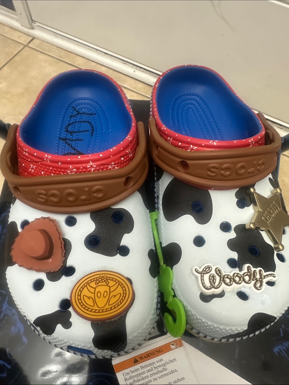 CROCS Woody Cow-Print Kids Clogs in White, Black, Blue, Brown